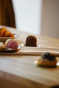 A selection of French pastries including croissants and macarons on a wooden table in Berlin.